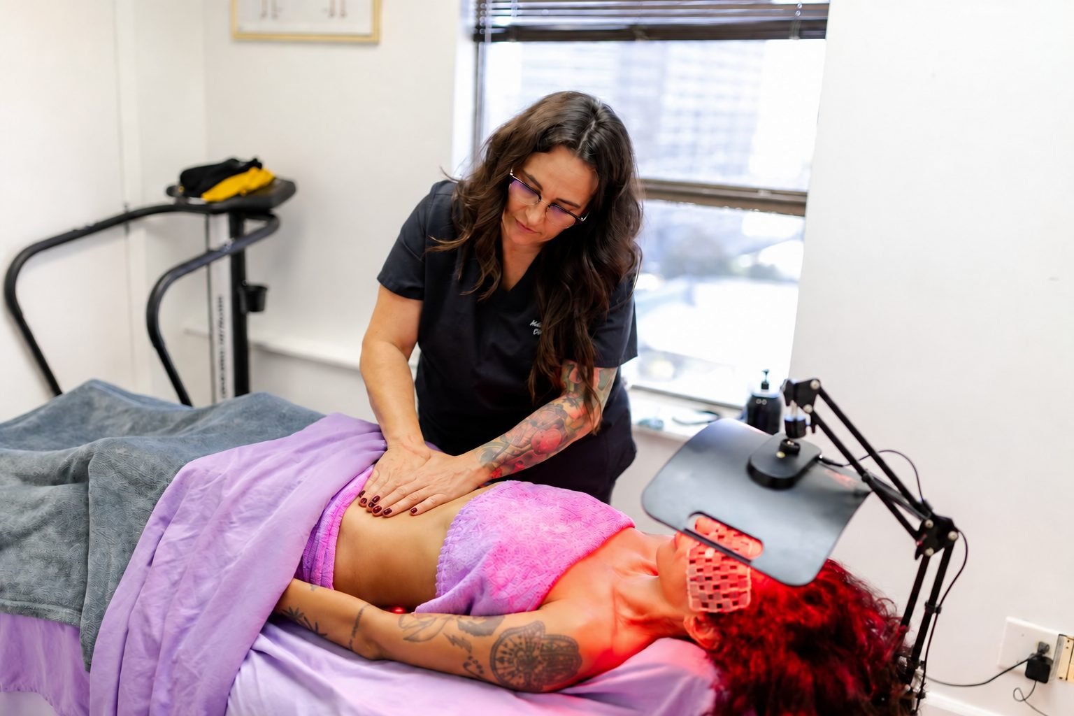 Natalie performing post-op abdominal lymphatic drainage on a client in the EIR studio